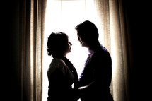 silhouette of an Indian couple in a window 