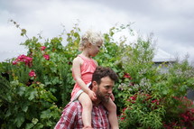 a daughter on her father's shoulders 