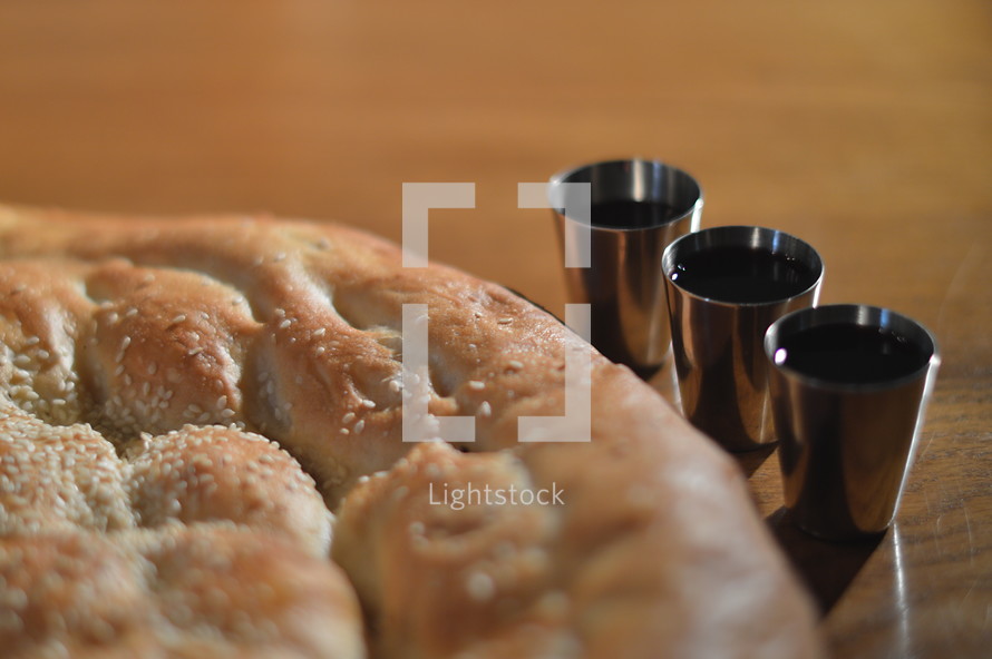 The Lord's Supper with bread and wine. 
bread, wine, cross, death, save, saviour, savior, salvation, supper, the Last Supper, the Lord's Supper, flesh, blood, spend, give, eta, eating, drink, drinking, redeem, redeemer, redemption, table, wooden, wood, cup, bible, scripture, Eucharist, Holy Sacrament, Communion, Holy Communion, partake, commune, communicant, receive, rescue, savage, saving, ransom, deliverance, sacrifice, sacrificial, sacrificial lamb, cups, jar, sacrificed, symbol, memory, reminder, remind, memento, remembrance, act, blood of Christ, body of Christ, goblet
