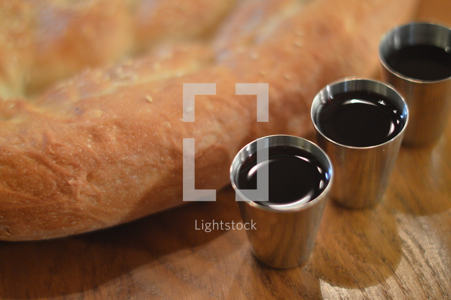 The Lord's Supper with bread and wine. 
bread, wine, cross, death, save, saviour, savior, salvation, supper, the Last Supper, the Lord's Supper, flesh, blood, spend, give, eta, eating, drink, drinking, redeem, redeemer, redemption, table, wooden, wood, cup, bible, scripture, Eucharist, Holy Sacrament, Communion, Holy Communion, partake, commune, communicant, receive, rescue, savage, saving, ransom, deliverance, sacrifice, sacrificial, sacrificial lamb, cups, jar, sacrificed, symbol, memory, reminder, remind, memento, remembrance, act, blood of Christ, body of Christ, goblet, Maundy thursday, inbetween