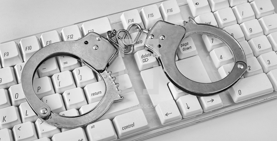 handcuffs over a computer keyboard 