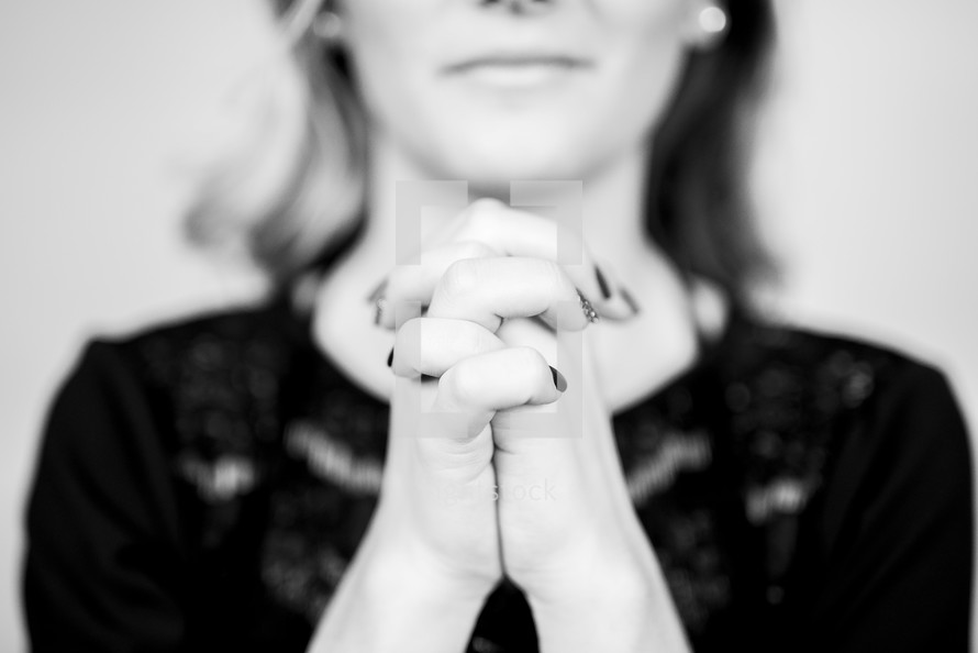 a woman with praying hands 