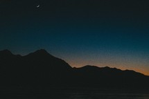 Mountain silhouette against a night sky.