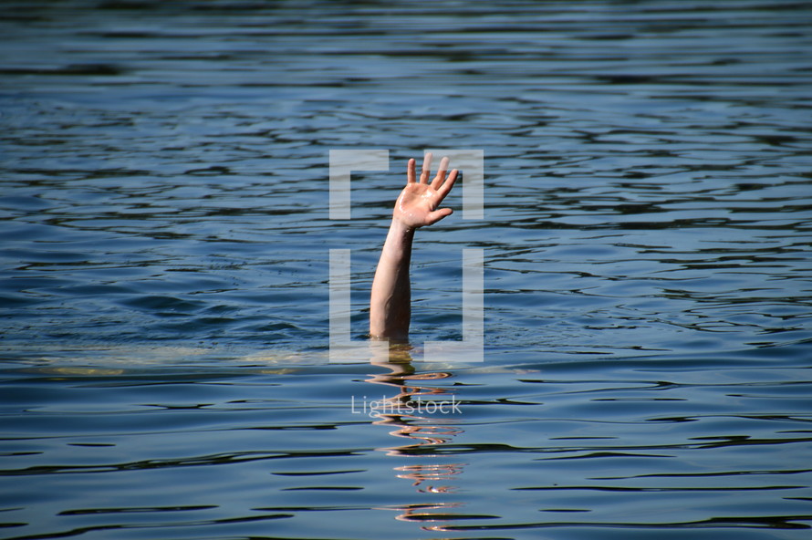 a hand raised out of the water for help