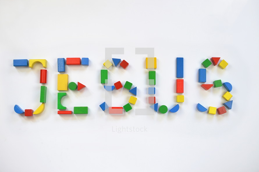 colorful wooden toy blocks lettering the name JESUS