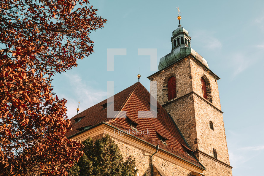 Church of St Henry and St Kunhuta in Prague. Autumn season, orange tree. Bohemia. High quality photo
