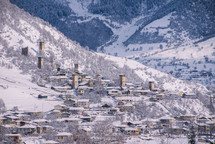 Snowy stone towers in a mountain village