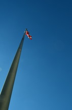 looking up to a flag on a flagpole 