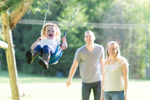 toddler girl on a swing 