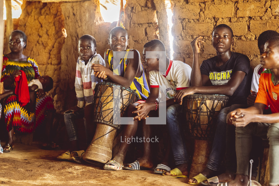 Christian African people playing drums, singing and dancing in a small village church in the Ivory Coast in west Africa
