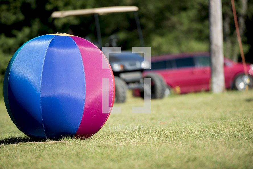 golf cart and beach ball on a lawn 