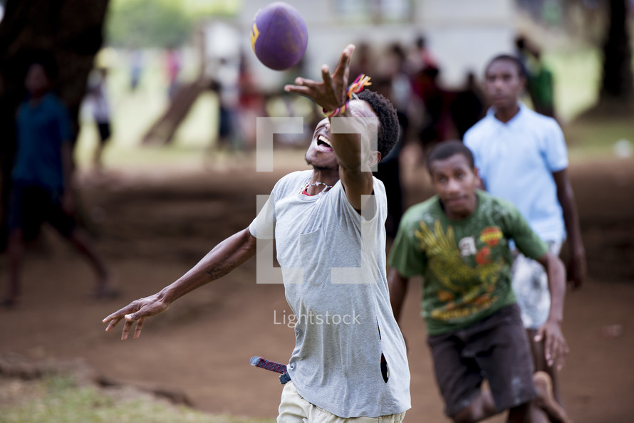 boys in a village playing football 