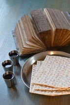 the Lord's Supper with bread, wine and an ancient open bible 