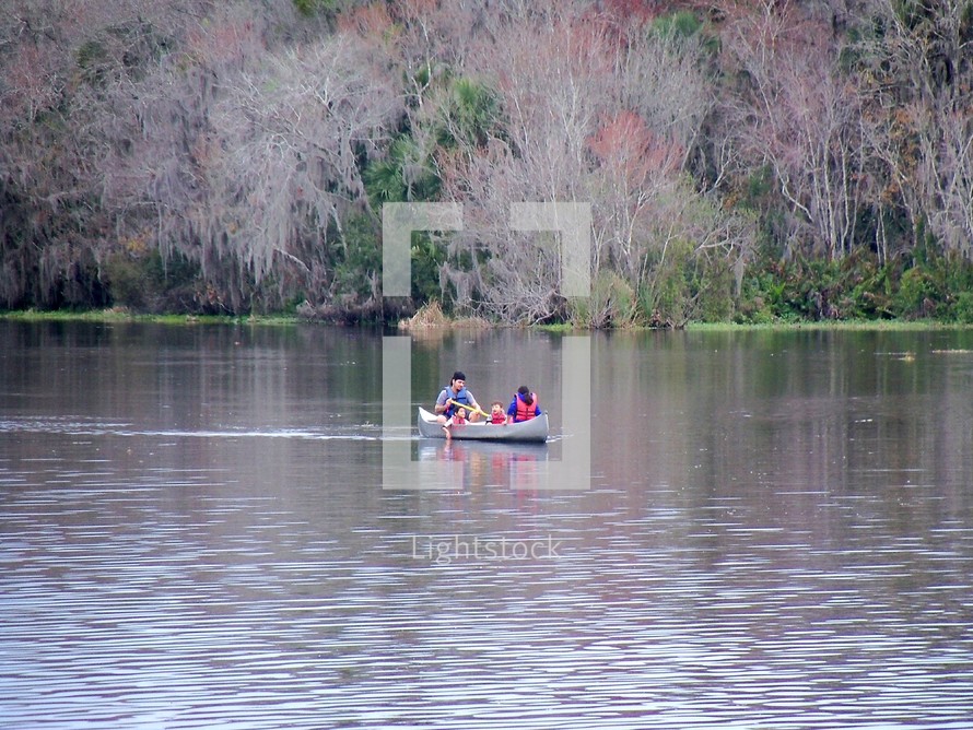 a family paddling in a canoe 