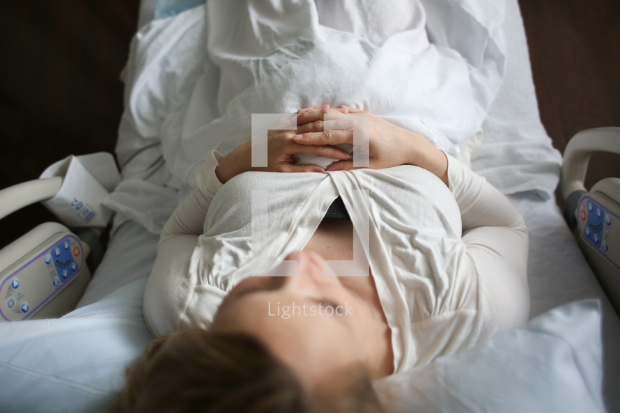 A woman lying in a hospital bed.