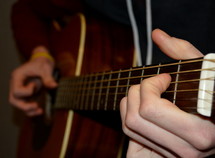 man playing an acoustic guitar 