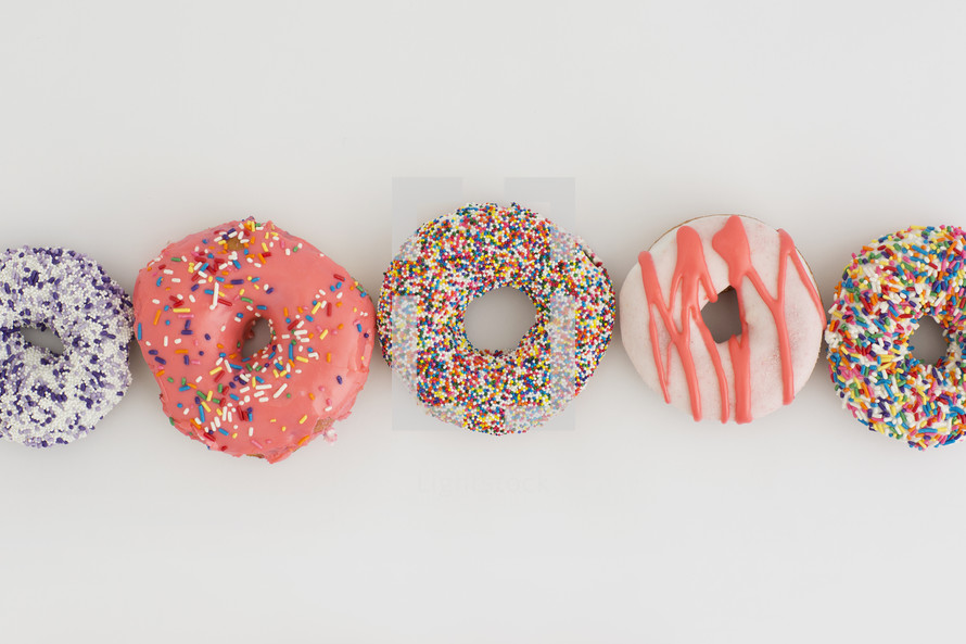 a row of sprinkled donuts 