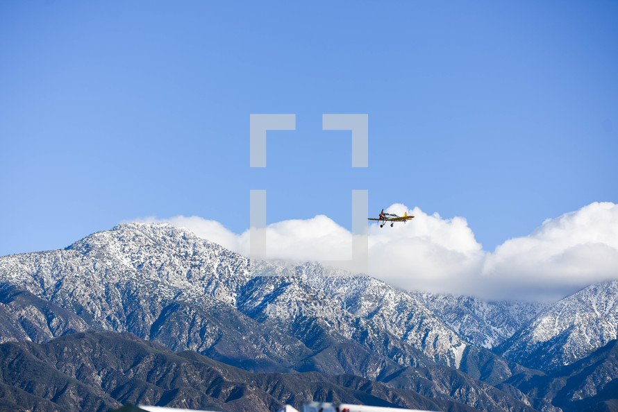 plane flying over mountains 