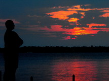silhouette of a man and a pink sky at sunset  
