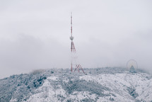 Foggy mast on a snowy hill