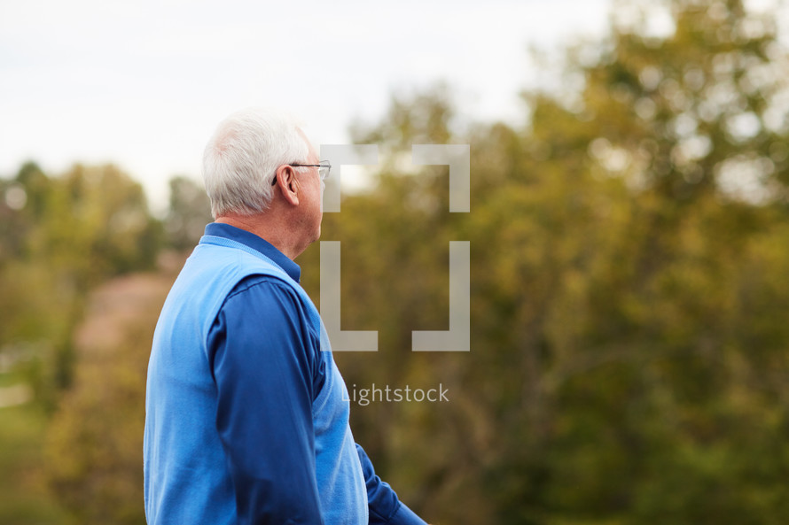 elderly man standing outdoors 