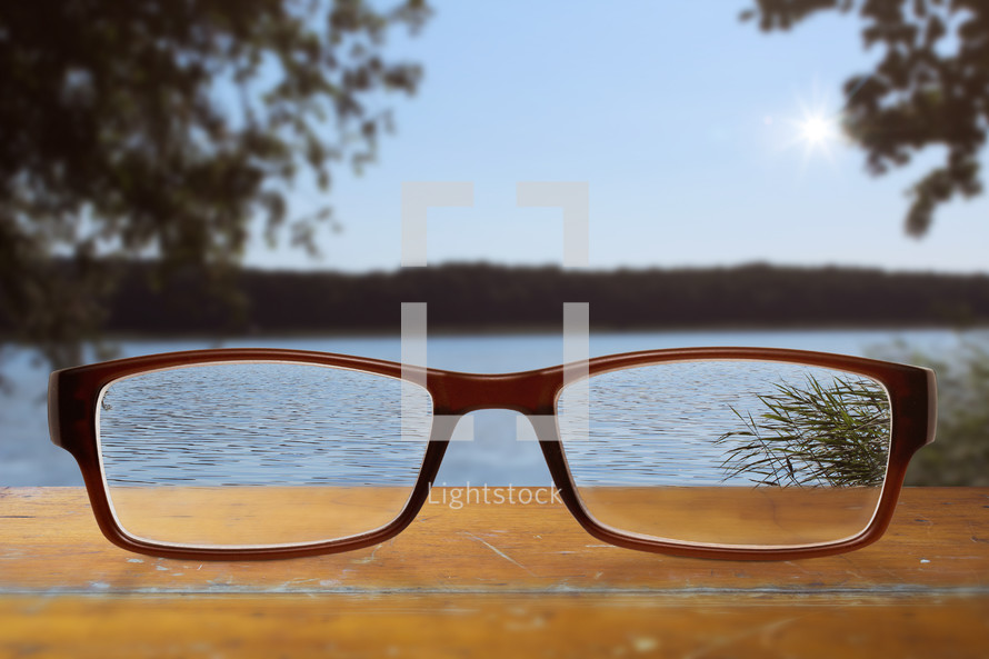 reading glasses and view of a lake 
