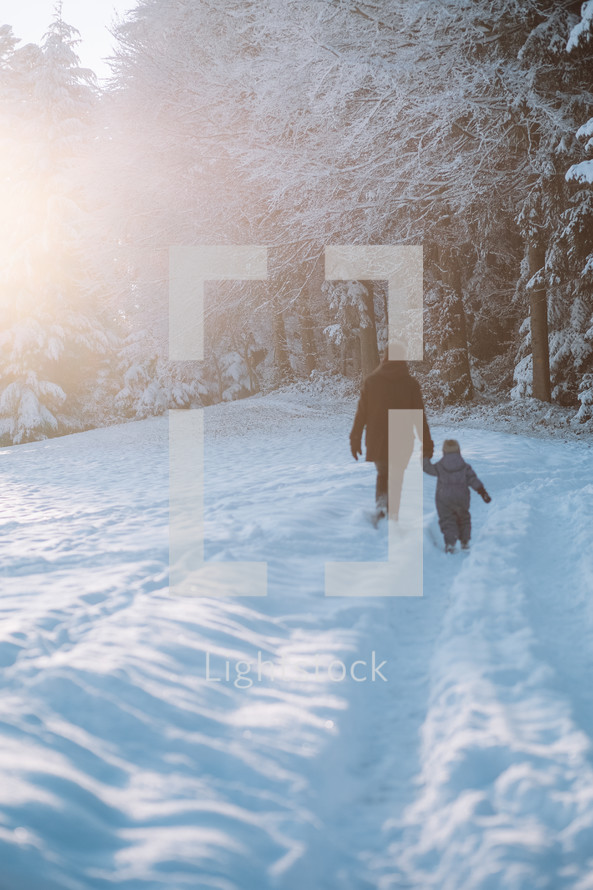 Father and son go for a walk in the snow