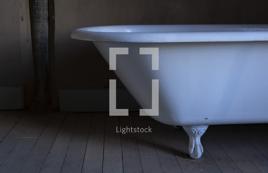 An antique clawfoot bathtub in an old building