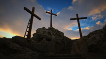 A sunny, beautiful sunrise/sunset at Golgotha on Easter morning featuring three crosses.