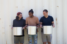 volunteers holding pots of soup at a soup kitchen 