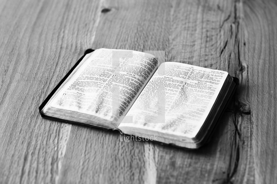 open Bible on wood table 