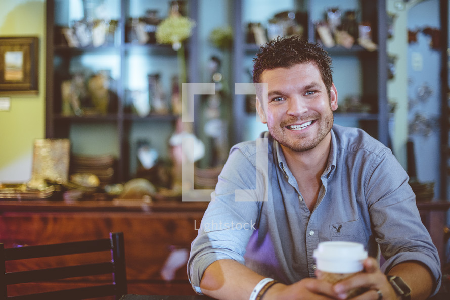 smiling man with a coffee cup 