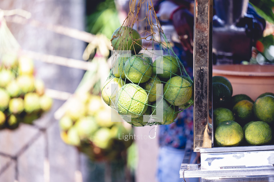 Bag of limes at a fruit stand in Kolkata, India.