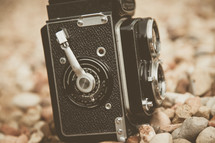 a vintage camera in rocks 