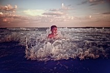 child playing in the ocean