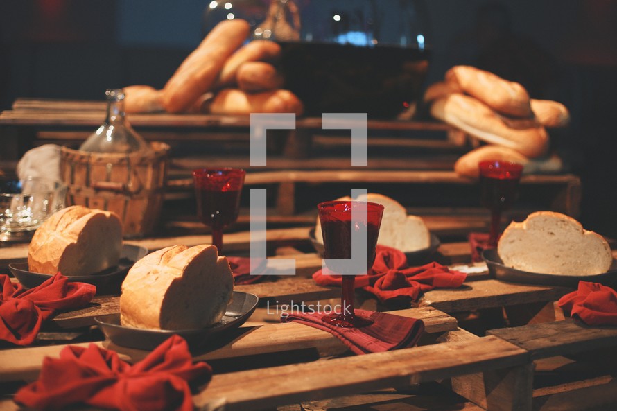 Bread and juice are displayed on a table setting for communion at a Good Friday Lord's Supper.