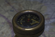An old vintage compass with map background