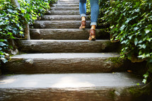 woman's feet walking up steps 