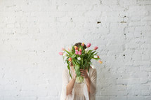 a woman holding a bouquet of spring tulips 