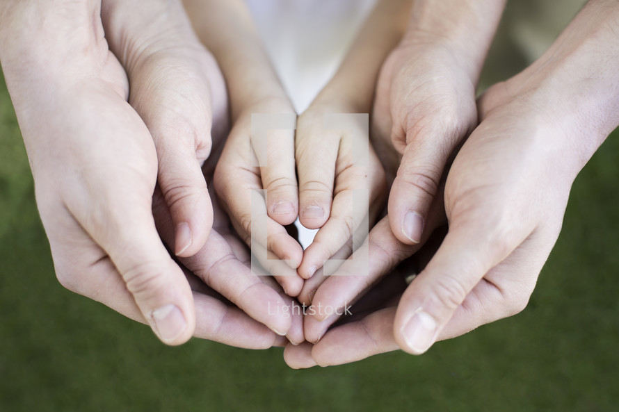 cupped hands of a family 