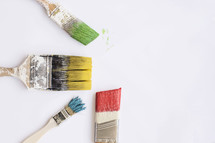 Paint brushes dipped in paint.