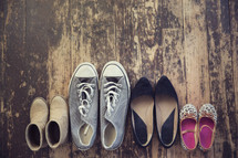 family shoes on an old wooden floor. 