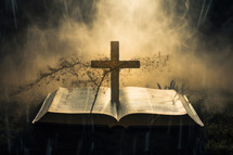 Open holy bible with wooden cross on dark toned foggy background