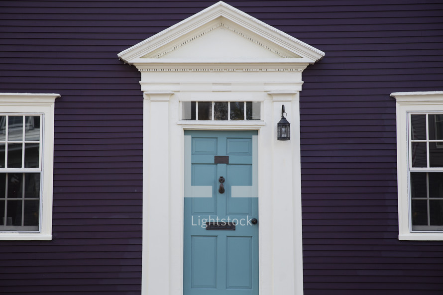 blue front door on a purple house 