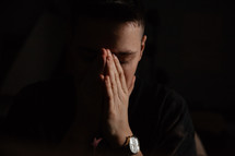 a distressed man praying 