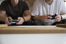 friends sitting on a couch playing video games 