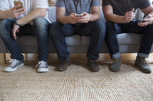 men looking at cellphone screens 