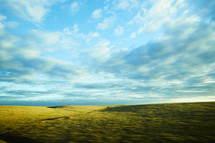 blue sky over a green prairie 