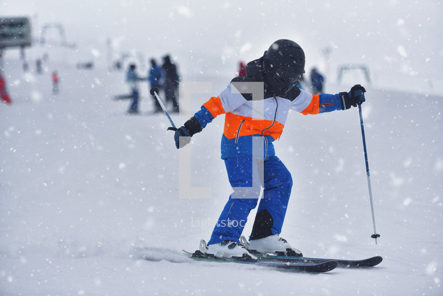 Young Skier Skis Through The Snowy Flurry 