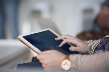 a woman using a tablet at a Bible study 